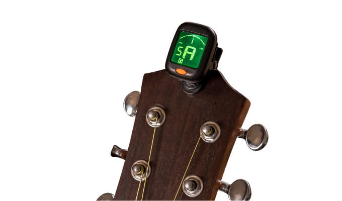 Gitarhode med et stemmeapparat klipset på.